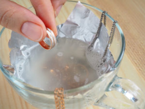 cleaning jewelry in a cup